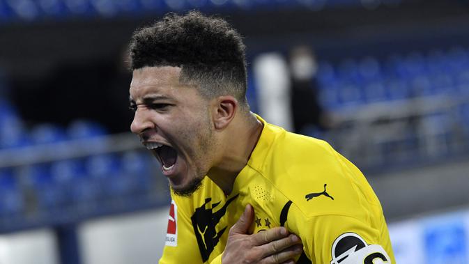 Gelandang Borussia Dortmund, Jadon Sancho melakukan selebrasi usai mencetak gol pertama timnya ke gawang Schalke dalam laga lanjutan Liga Jerman 2020/21 pekan ke-22 di Veltins Arena, Sabtu (20/2/2021). Borussia Dortmund menang 4-0 atas Schalke. (AP/Martin Meissner/Pool)