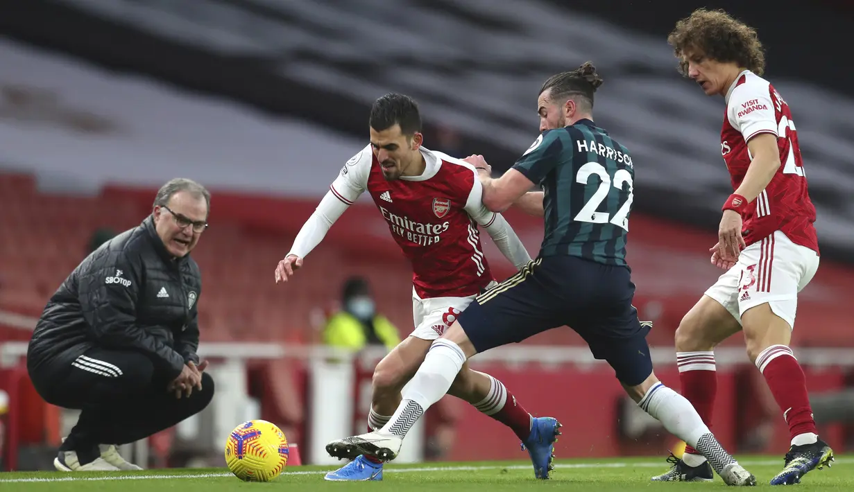 Gelandang Arsenal, Dani Ceballos (kiri) berusaha melewati hadangan gelandang Leeds United, Jack Harrison dalam laga lanjutan Liga Inggris 2020/21 pekan ke-24 di Emirates Stadium, London, Minggu (14/2/2021). Arsenal menang 4-2 atas Leeds United. (AP/Catherine Ivill/Pool)