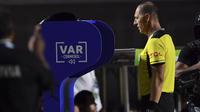 Wasit Nestor Pitana memeriksa VAR pada laga Copa America 2019 antara Brasil dan Bolivia. (AFP/Pedro Ugarte)