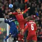 Bek Liverpool, Virgil Van Dijk berebut bola dengan pemain Red Star Belgrade, El Fardou Ben Nabouhane selama pertandingan grup C Liga Champions di stadion Anfield, Inggris (24/10). Liverpool menang telak 4-0 atas Red Star. (AP Photo/Jon Super)