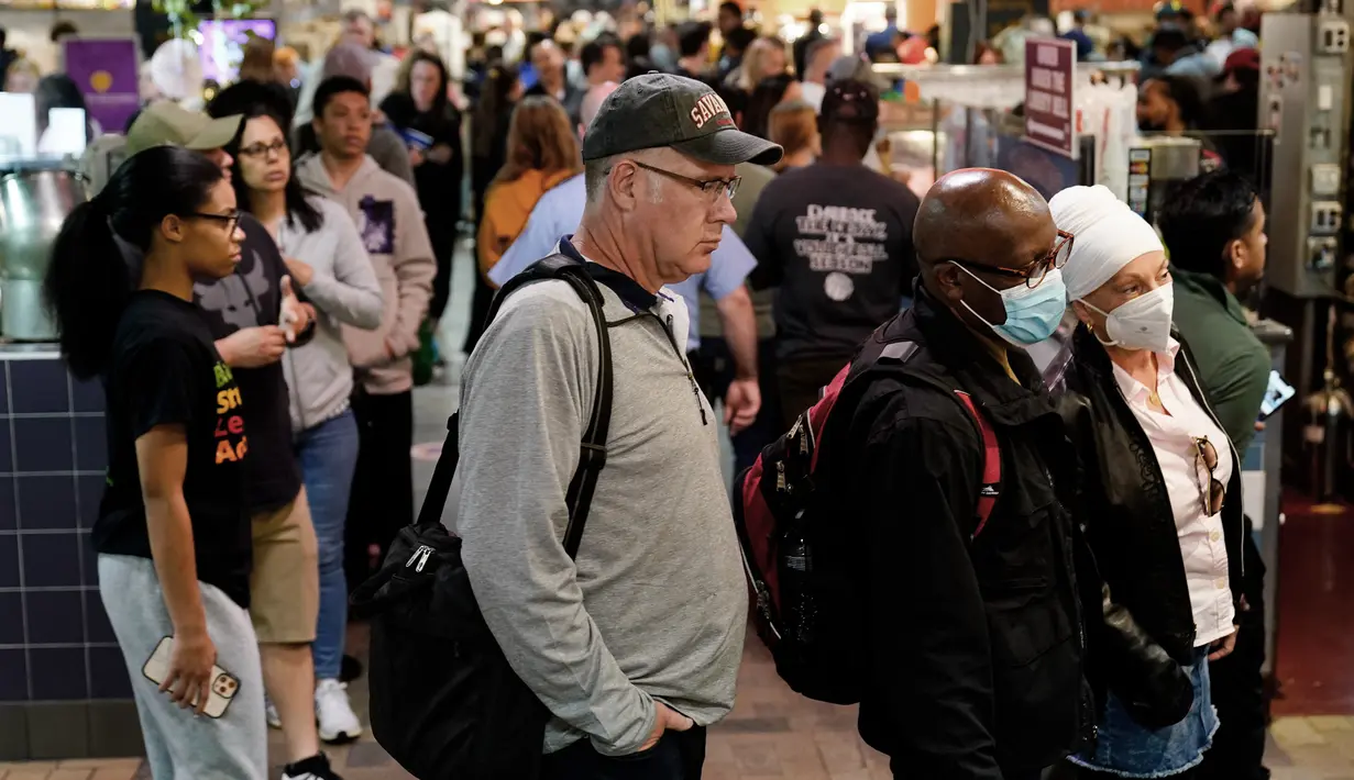 <p>Pelanggan, beberapa mengenakan masker, mengunjungi Reading Terminal Market di Philadelphia, Jumat (22/4/2022). Kota itu meninggalkan mandat masker dalam ruangan pada hari Jumat, hanya beberapa hari setelah menjadi kota metropolitan AS pertama yang menerapkan kembali wajib masker sebagai tanggapan atas peningkatan kasus COVID-19 dan rawat inap. (AP Photo/Matt Rourke)</p>