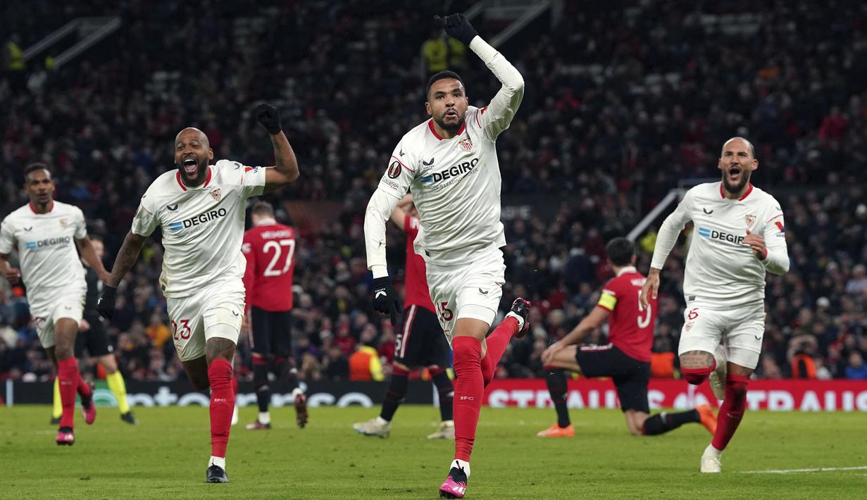 <p>Pemain Sevilla merayakan gol bunuh diri yang dicetak oleh pemain Manchester United, Harry Maguire pada laga leg pertama perempat final Liga Europa 2022/2023 di Old Trafford, Manchester, Jumat (14/04/2023) dini hari WIB. Laga berakhir dengan skor 2-2. (AFP/Darren Staples)</p>