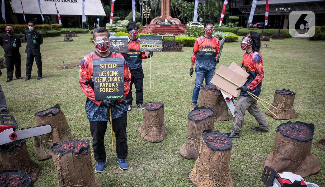 Sejumlah orang yang tergabung dalam Greenpeace menggelar aksi di Kementerian LHK, Jakarta, Kamis (8/4/2021). Mereka menentang rencanan perusakan Hutan Papua yang masih ada di dalam areal perkebunan yang belum dirusak bisa dikembalikan kepada masyarakat adat Papua. (Liputan6.com/Faizal Fanani)
