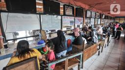 Petugas tiket saat melayani calon penumpang yang akan mudik menggunakan bus AKAP di Terminal Kampung Rambutan, Jakarta, Senin (25/4/2022). Berdasarkan data per Minggu (24/4), sebanyak 1.118 penumpang berangkat dari terminal ini. (merdeka.com/Iqbal S. Nugroho)