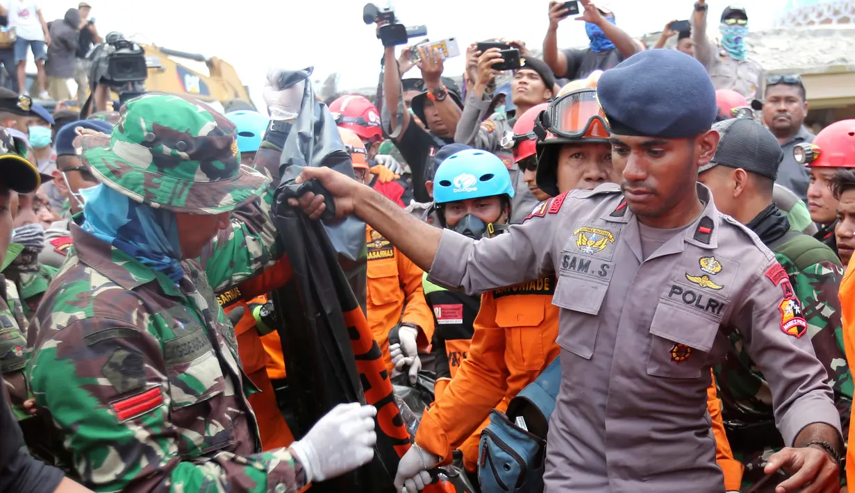 Tim SAR mengevakuasi jenazah korban gempa dari reruntuhan Masjid Jamiul Jamaah di Bangsal, Lombok Utara, Rabu (8/8). Berdasarkan kesaksian warga, diduga puluhan korban yang sedang melaksanakan pengajian tertimbun bangunan masjid. (AP/Tatan Syuflana)