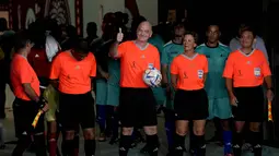 Presiden FIFA Gianni Infantino (tengah) masuk bersama wasit dan pemain untuk pertandingan persahabatan antara pekerja dan FIFA Legends di Stadion Al Thumama di Doha, Qatar, Senin (12/12/2022). Mengikuti pertandingan terakhir di FIFA Piala Dunia Qatar 2022 Stadion Al Thumama, para tamu dan sukarelawan melihat para pekerja beberapa di antaranya memenangkan edisi terakhir Piala Pekerja, bermain berdampingan dengan beberapa nama sepak bola terbesar dalam pertarungan 60 menit.(AP Photo/ Frank Augstein)