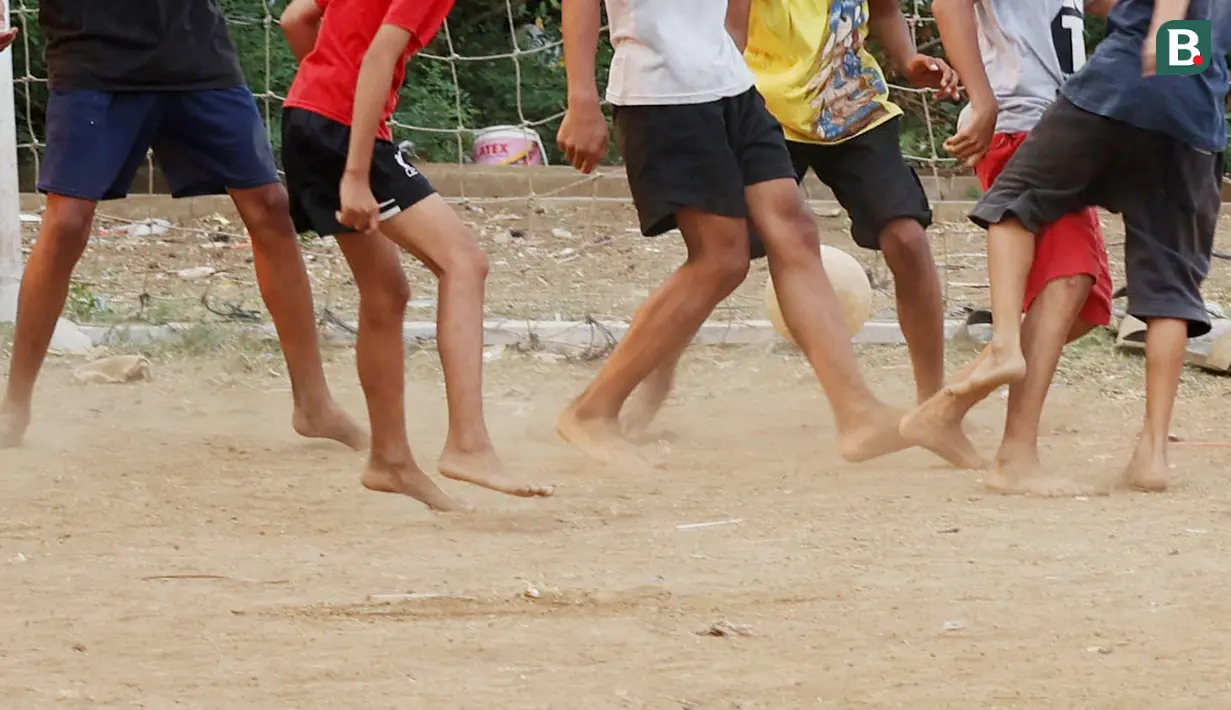 Tanpa alas kaki, bocah-bocah ini dengan lincah mengejar dan menendang bola tanpa khawatir akan cedera. (Bola.com/M Iqbal Ichsan)