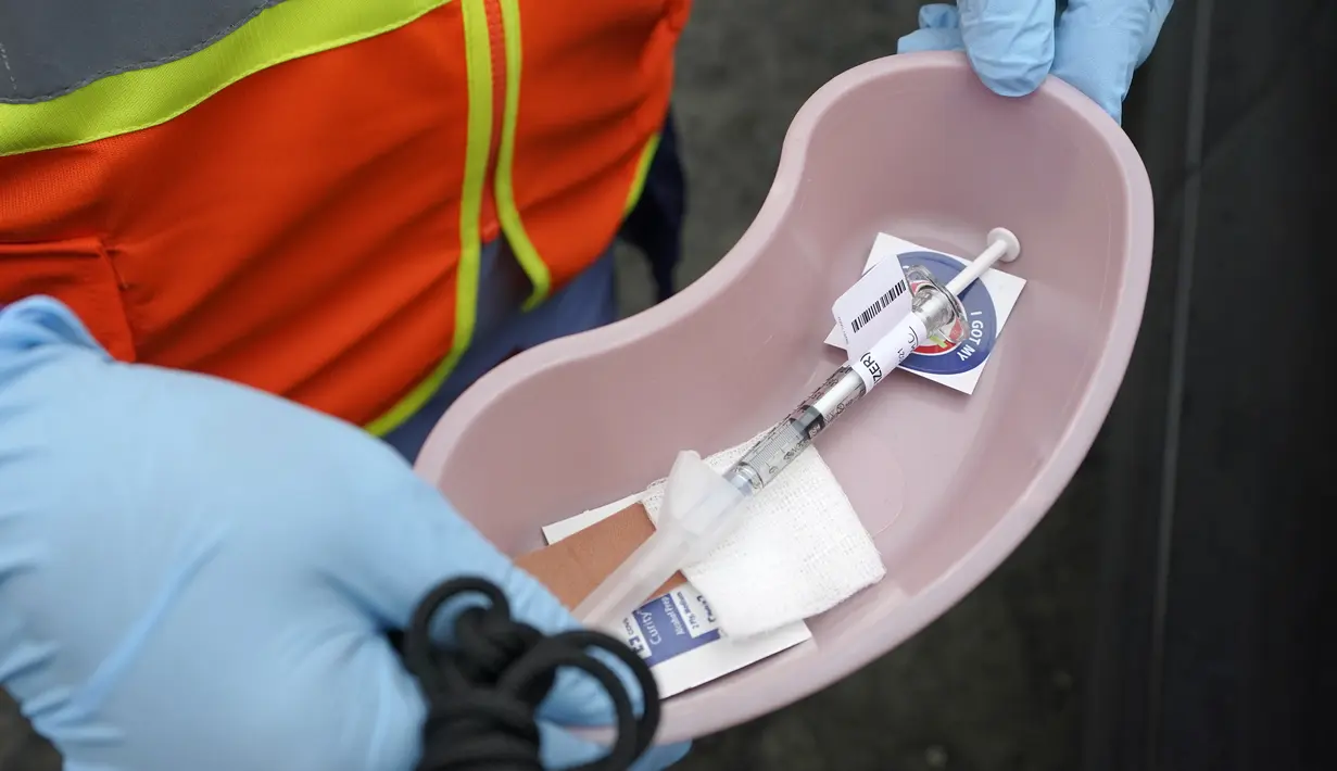 Seorang petugas medis memegang nampan dengan dosis vaksin Pfizer COVID-19 untuk para veteran Amerika Serikat, di Shelton, Washington, Kamis (4/3/2021). Veteran segala usia bisa mendapatkan vaksin di klinik Puget Sound VA.  (AP Photo/Ted S. Warren)