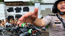 Petugas berusaha menghalangi media yang ingin mengambil gambar sweeping Go-Jek di kawasan Senayan, Jakarta Pusat, Selasa (22/3). Mereka akan dimintai keterangan oleh pihak kepolisian. (Liputan6.com/Fery Pradolo)