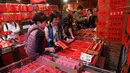 Orang-orang berbelanja untuk persiapan Tahun Baru Imlek di pasar Dihua Street di Taipei, Selasa (29/1). Warga Taiwan mulai berburu makanan lezat, kue kering dan barang-barang diskon di pasar menjelang Imlek pada 5 Februari 2019. (AP/Chiang Ying-ying)