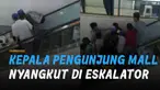 Seorang pria alami nasib apes ketika kepalanya nyangkut di eskalator mal.