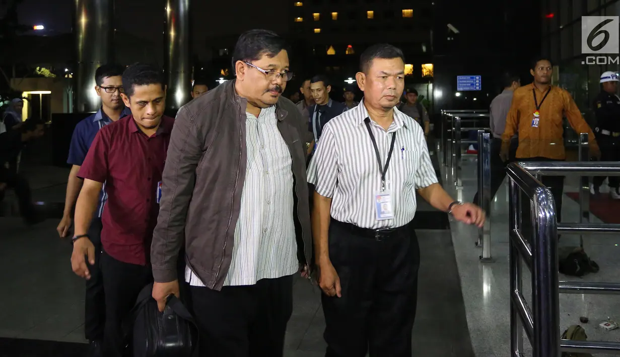 Kepala Dinas Pekerjaan Umum dan Penataan Ruang (PUPR) Tulungagung, Sutrisno (tengah) saat tiba di Gedung KPK, Jakarta, Kamis (7/6). Sutrisno bersama tiga orang lainnya tiba di KPK untuk menjalani pemeriksaan. (Liputan6.com/Herman Zakharia)