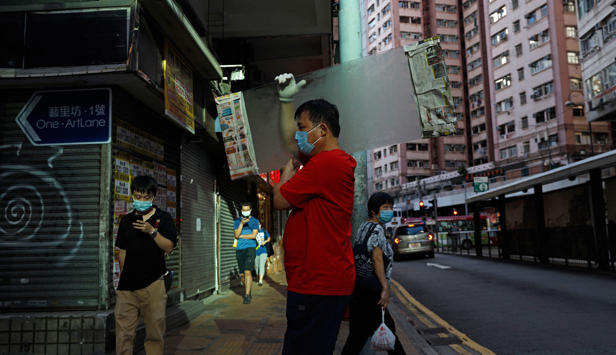 Orang-orang yang memakai masker berjalan di jalanan di Hong Kong, Rabu (22/7/2020). Hong Kong menghadapi "tahap kritis" dalam perjuangannya melawan COVID-19, dan pemerintah sedang memperpanjang langkah-langkah baru untuk menjaga jarak sosial. (AP Photo/Kin Cheung)