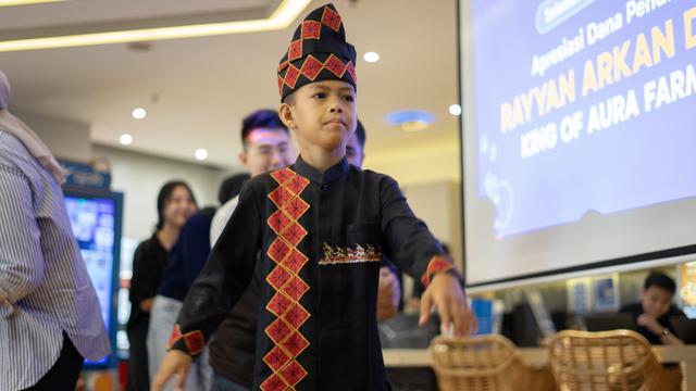 Seorang anak berusia 11 tahun dari Riau bernama Rayyan Arkan Dhika belajar terkait literasi keuangan saat Hari Anak Nasional.