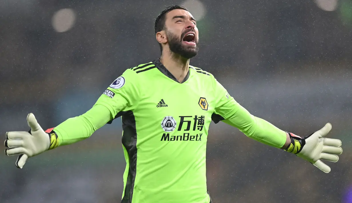Selebrasi kiper Wolverhampton Wanderers, Rui Patricio saat menghadapi Arsenal pada laga Liga Inggris 2020/2021 di Molineux Stadium, Wolverhampton (2/2/2021). Rui Patricio mulai membela Sporting Lisbon sejak dipromosikan dari Sporting U-19 pada awal musim 2006/2007. Setelah 12 musim, pada awal musim 2018/2019 ia memutuskan hirah ke Premier League untuk membela Wolverhampton dan bertahan selama 3 musim hingga 2020/2021. (AFP/Shaun Botterill)