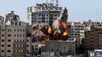Bola api meletus dari gedung yang menampung berbagai media internasional, termasuk The Associated Press, setelah serangan udara Israel di Kota Gaza, Sabtu (15/5/2021). Gedung tersebut juga menampung Al Jazeera dan sejumlah kantor serta apartemen. (Mahmud Hams /Pool Photo via AP)