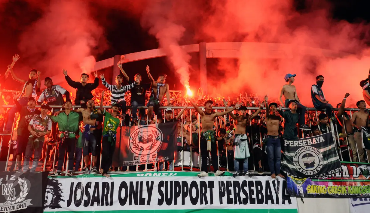 Suporter tim Bajul Ijo bernyanyi dan menyalakan suar usai menyaksikan laga penyisihan Dirgantara Cup 2017 antara Persebaya melawan Cilegon Utd di Stadion Maguwoharjo, Sleman, Sabtu (4/3). Persebaya kalah 1-2. (Liputan6.com/Helmi Fithriansyah)