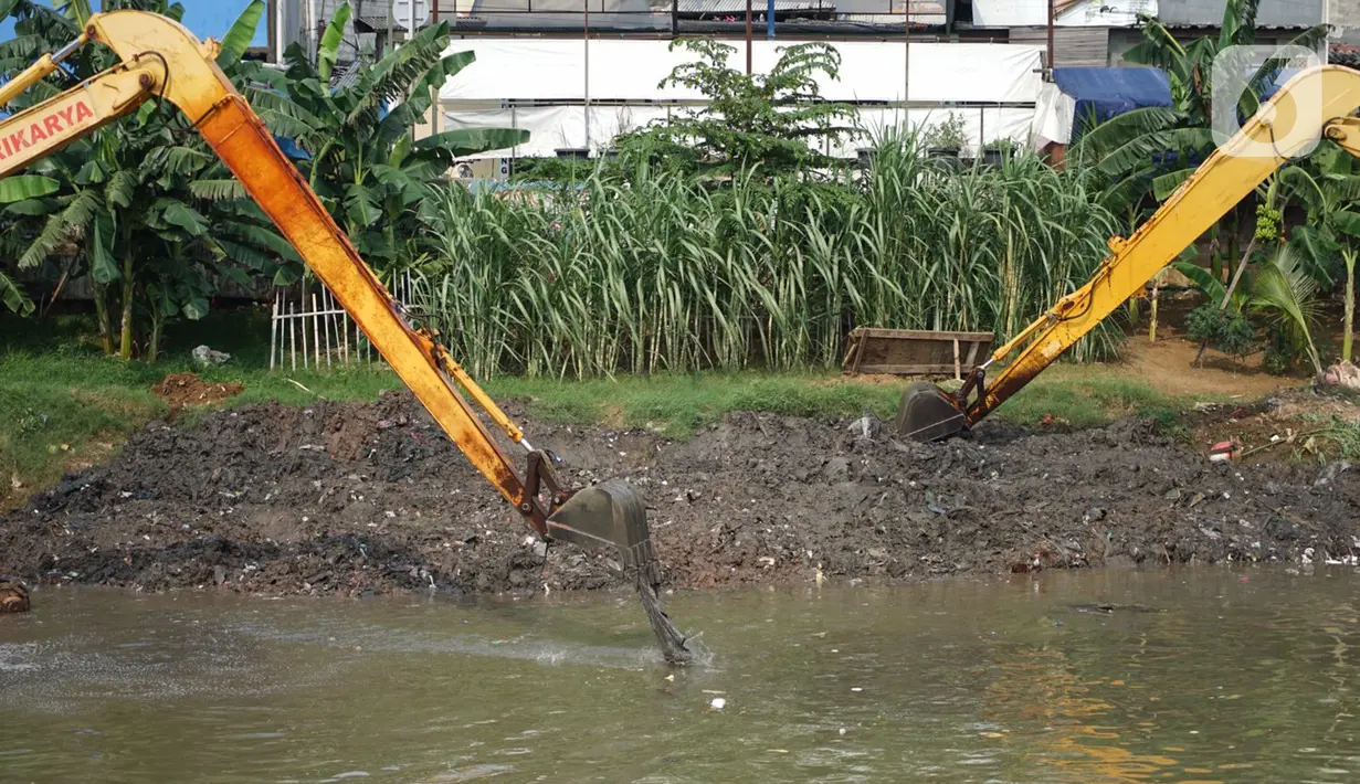 Alat berat mengeruk sampah bercampur lumpur di aliran Banjir Kanal Barat, Jakarta, Rabu (14/10/2020). Pengerukan serta pembersihan waduk, sungai, dan saluran air dari lumpur juga sampah untuk mencegah pendangkalan serta mengantisipasi banjir saat musim hujan. (Liputan6.com/Immanuel Antonius)