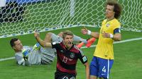 Thomas Muller merayakan golnya ke gawang Brasil saat Jerman membantai Tim Samba 7-1 di Piala Dunia 2014 (Gabriel Bouys / AFP)