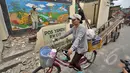 Seorang warga saat melintas didepan salah satu bangunan liar yang digusur di Jalan Subur Baru, Jakarta, Senin (23/2/2015). Pemprov DKI Jakarta bertujuan melakukan pelebaran jalan dari empat meter menjadi tujuh meter.(Liputan6.com/Faizal Fanani)
