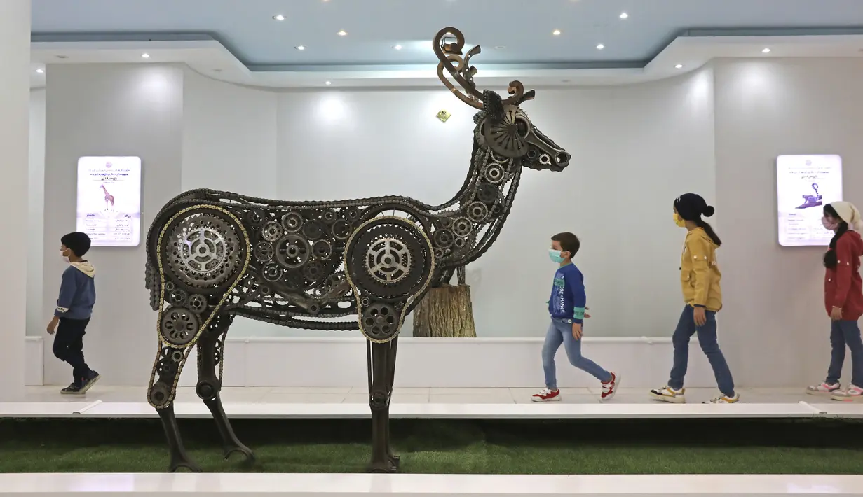 Anak-anak mengunjungi area indoor Shahreza Metal Zoo di pusat kota Shahreza sekitar 425 kilometer selatan ibu kota Teheran, Iran pada 13 Oktober 2021. Kebun binatang ini tidak menampilkan hewan asli, melainkan replika binatang yang dibuat dari logam. (AP Photo/Vahid Salemi)