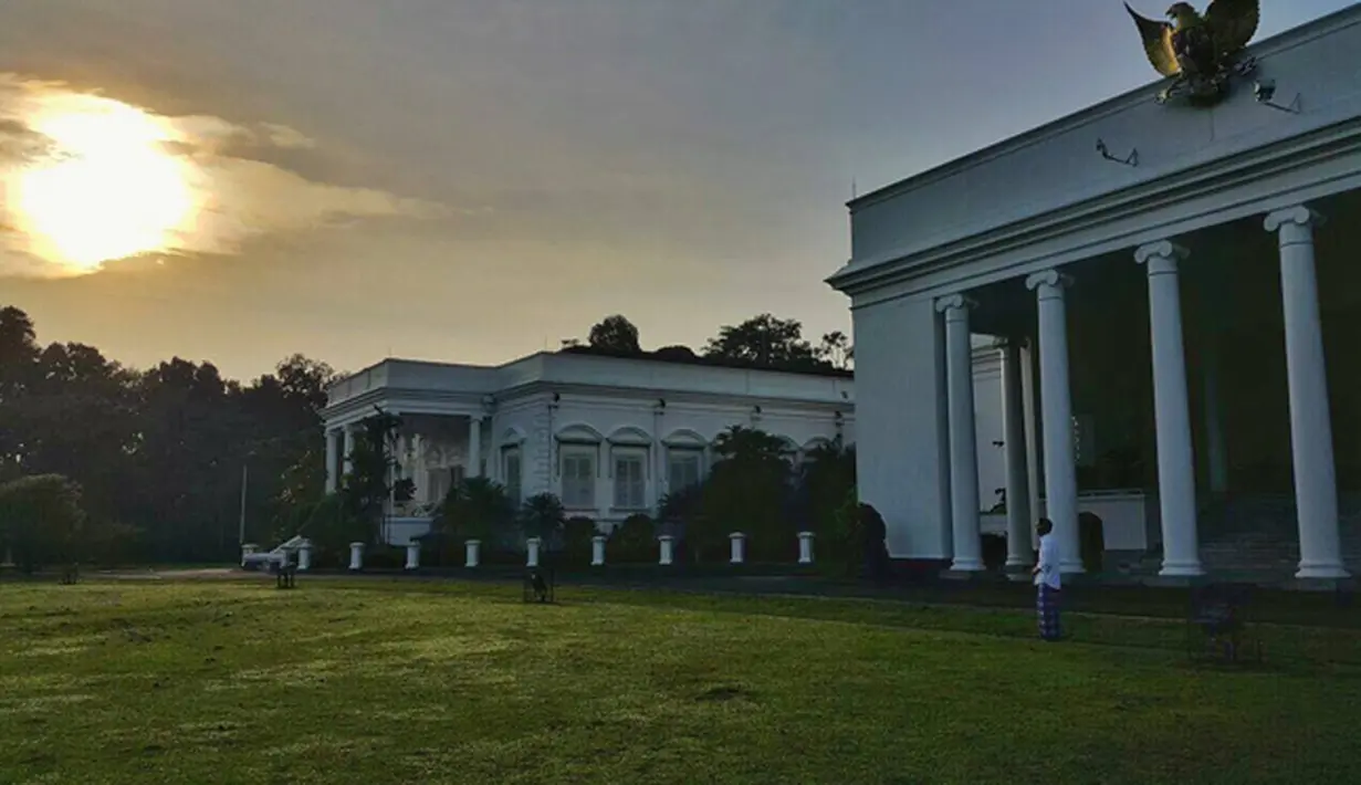 Suasana di Halaman Istana Bogor saat gerhana tengah berlangsung. Dengan mengenakan kemeja putih dan sarung kotak-kotak berwarna biru, Jokowi tampak santai menyaksikan gerhana matahari di halaman Istana Bogor, Rabu (9/3). (facebook.com/Jokowi)