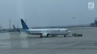 Pesawat Garuda Indonesia terparkir di Terminal 3 bandara Soekarno Hatta, Tangerang, Banten, Rabu (24/7/2019). Maskapai penerbangan Garuda Indonesia  mengeluarkan kebijakan terbaru terkait pengambilan gambar ataupun video di dalam pesawat oleh penumpang ataupun awak kabin. (Liputan6.com/Angga Yuniar)