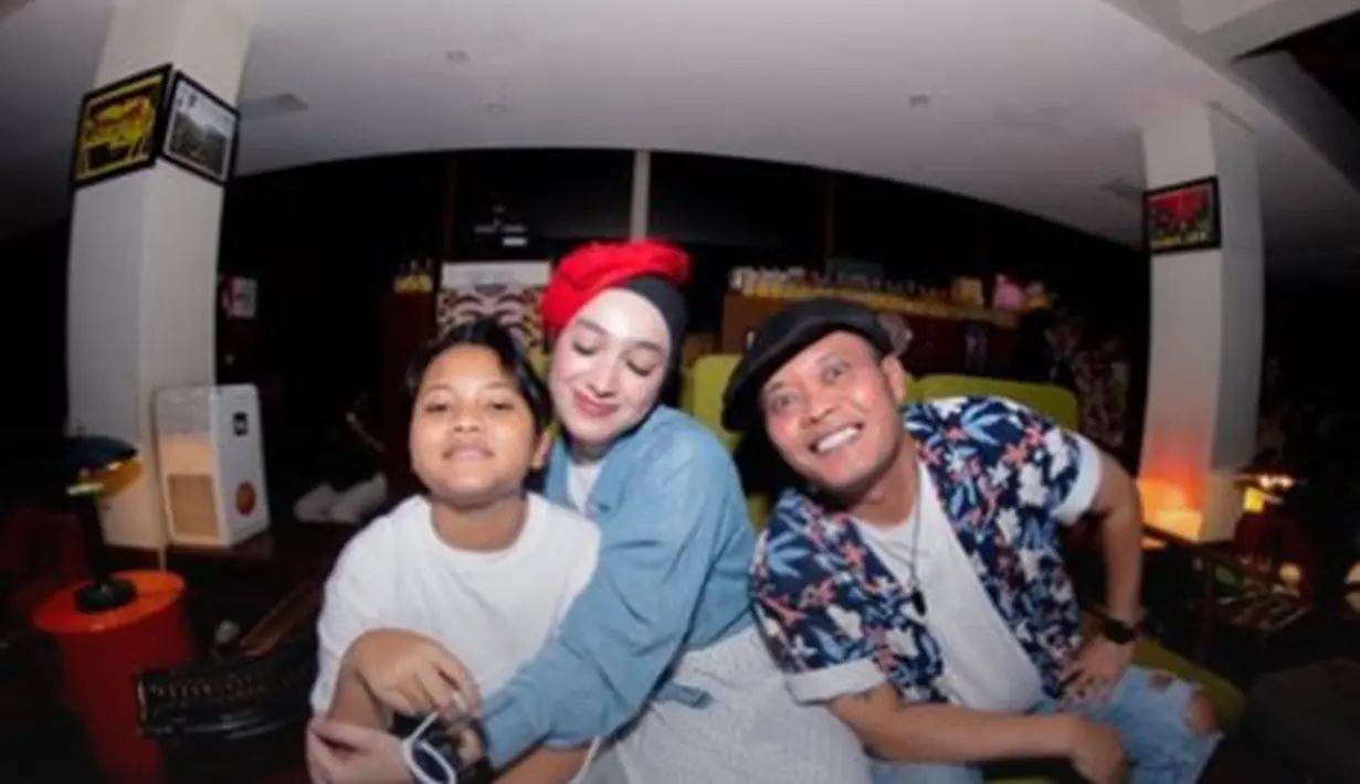 Hijab polos hitam yang diberi sentuhan aksesori topi merah kecil semakin mempermanis penampilan Santyka di sini. [Foto: Instagram/santykafauziah]