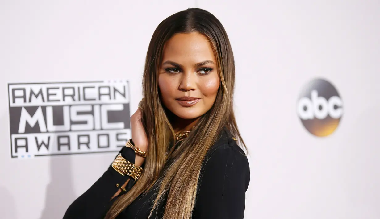 Model Chrissy Teigan berpose di karpet merah perhelatan American Music Awards (AMA) 2016 di Los Angeles, California, Minggu (20/11). Chrissy Teigen tampil dengan gaun super seksi saat menemani suaminya, John legend. (REUTERS/Danny Moloshok)