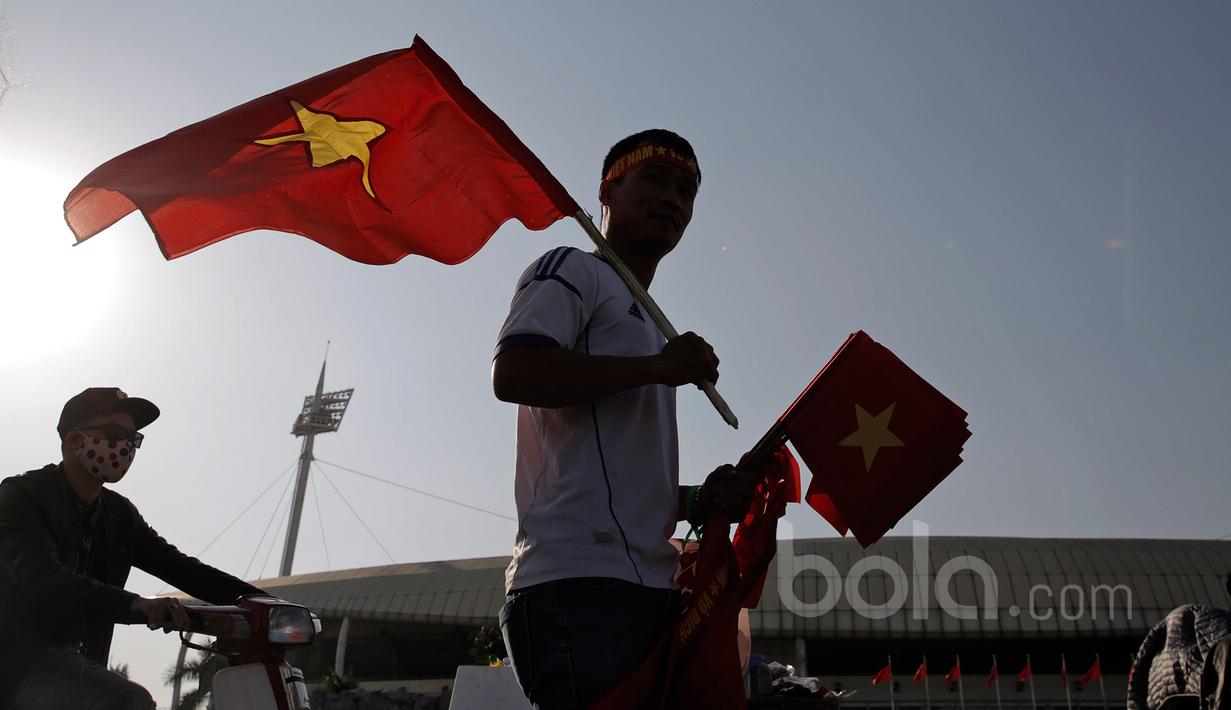 Fans Vietnam siap membagikan bendera kepada pendukung sebelum laga semifinal Piala AFF 2016 di Stadion Nasional My Dinh, (07/12/2016). (Bola.com/Peksi Cahyo)