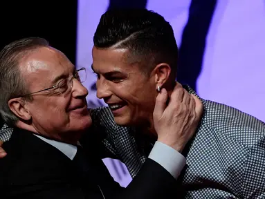 Penyerang Juventus, Cristiano Ronaldo memeluk presiden Real Madrid, Florentino Perez  usai mandapat ucapan selamat setelah meraih penghargaan media olahraga top Spanyol, Marca di Reina Victoria Theater, Madrid (29/7/2019). (AFP Photo/Javier Soriano)