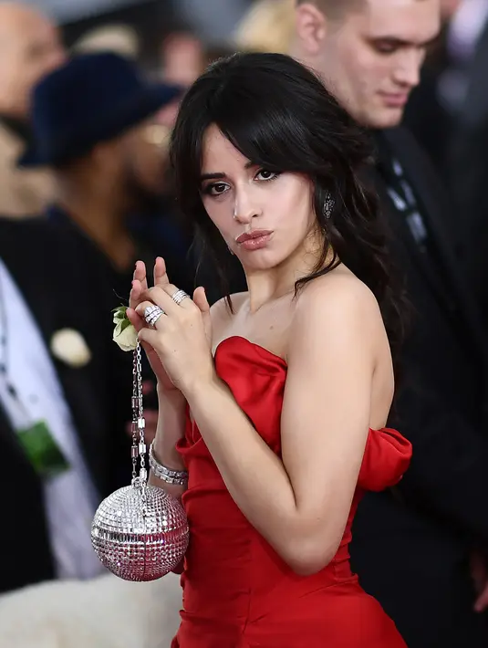 Penyanyi Camila Cabello menghadiri karpet merah ajang musik bergengsi Grammy Awards 2018 di New York, Minggu (28/1). Gaya Camila disempurnakan dengan perhiasan berlian serta clutch berbentuk lampu bola disko warna silver. (AFP PHOTO/Jewel SAMAD)