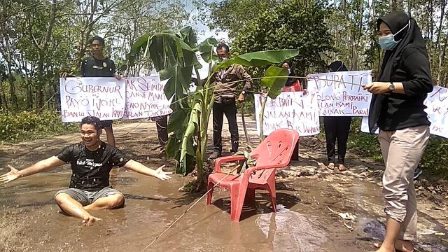 Sindir Pemerintah, Warga Ogan Ilir Mandi Air Comberan di Lubang Jalan