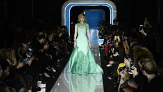 Model AS, Gigi Hadid berjalan membawakan koleksi terbaru Moschino di panggung runway Milan Fashion Week 2018, Rabu (21/2). Gigi terlihat cantik dengan gaun warna hijau muda beraksen sparkling di bagian lengan dan leher serta kakinya. (Miguel MEDINA/AFP)