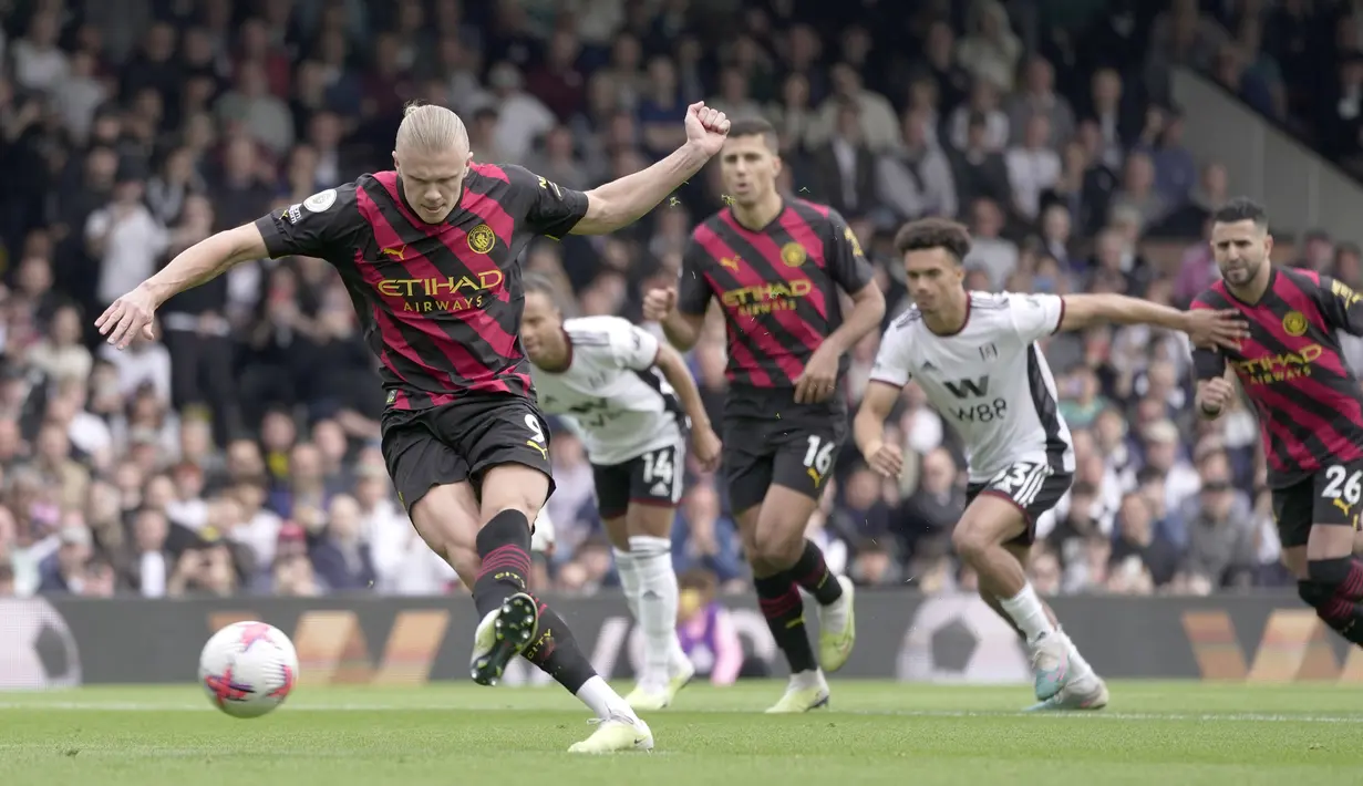 Pemain Manchester City, Erling Haaland (kiri), berhasil menjebol gawang Fulham dari titik penalti dalam pertandingan pekan ke-34 Premier League 2022/2023 yang berlangsung di Craven Cottage, Minggu (30/4/2023). (AP Photo/Kin Cheung)