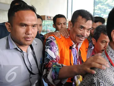 Wali Kota Madiun Bambang Irianto berjalan menuju mobil tahanan usai menjalani pemeriksaan di gedung KPK, Jakarta, Rabu (23/11). KPK resmi menahan Bambang Irianto terkait dugaan kasus korupsi Pasar Besar Madiun tahun 2009-2012. (Liputan6.com/Helmi Afandi)