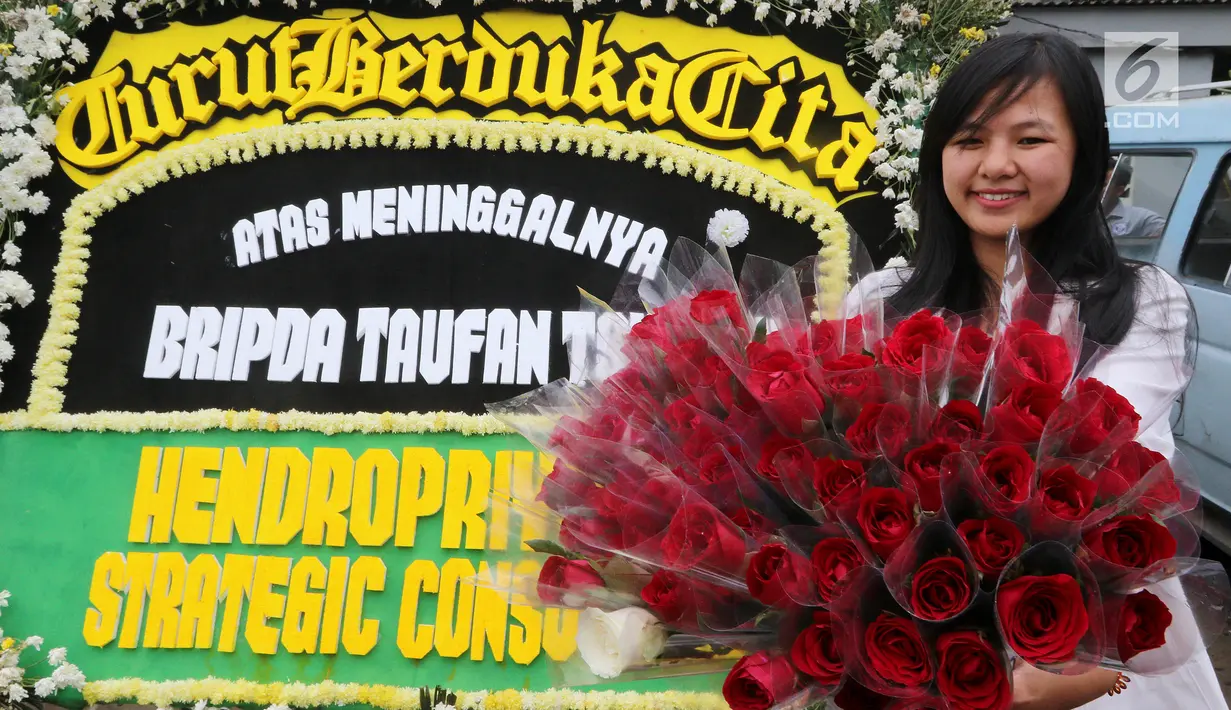 Peserta aksi menunjukkan bunga saat menyelenggarakan aksi simpatik di lokasi kejadian bom di Kampung Melayu, Jakarta, Minggu (28/5). (Liputan6.com/Johan Tallo)