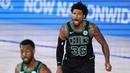Pebasket Boston Celtics, Marcus Smart, melakukan selebrasi usai memasukkan bola saat melawan Toronto Raptors pada laga NBA di Lake Buena Vista, Senin (7/9/2020). Boston Celtics menang telak 111-89 atas Toronto Raptors. (AP/Mark J. Terrill)