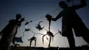 Nelayan Palestina mengenakan masker saat mereka melepaskan kepiting dari jaring di pantai laut Mediterania di Beit Lahyia, Jalur Gaza utara pada 21 September 2020. (AP Photo / Hatem Moussa)