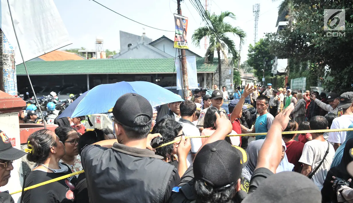 Kerumunan warga setempat menyaksikan rekonstruksi pembunuhan satu keluarga di Bojong Nangka II, Bekasi, Jawa Barat, Rabu (21/11). Rekonstruksi ini digelar oleh Tim Inafis Polda Metro Jaya dan Polres Metro Bekasi. (Merdeka.com/Iqbal S. Nugroho)