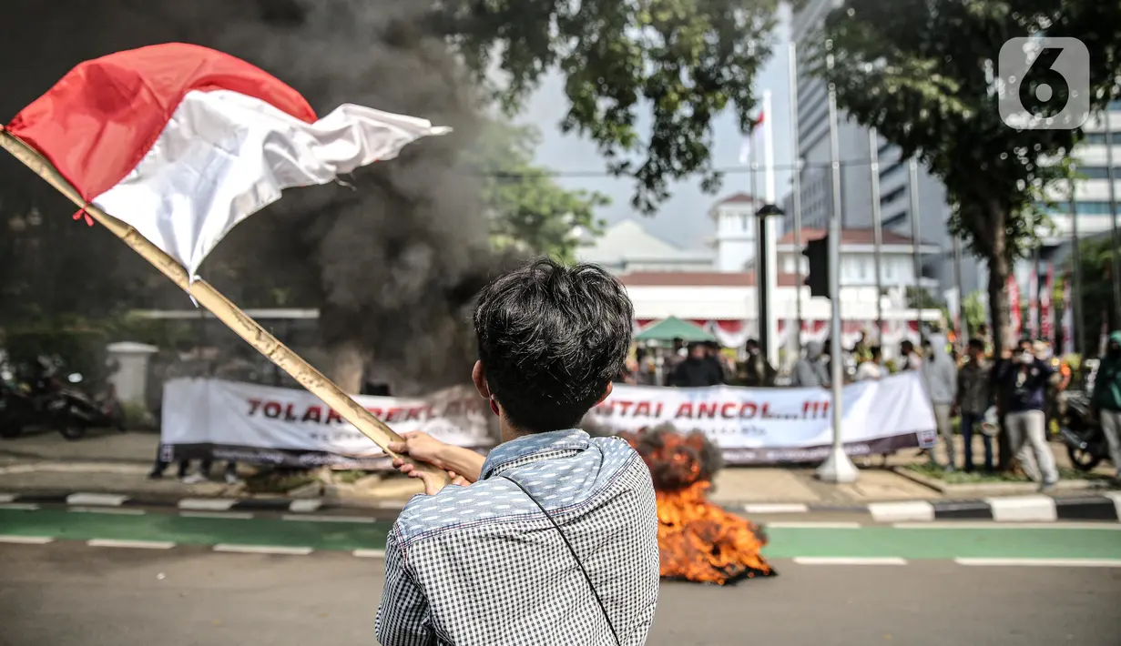 Aksi Bakar Tolak Reklamasi Pantai Ancol: Pengunjuk rasa  mengibarkan bendera merah putih didepan Balaikota, Jakarta, Rabu (8/7/2020). Mereka meminta Gubernur DKI Jakarta Anies Baswedan untuk menghentikan Reklamasi Pantai Ancol. (Liputan6.com/Faizal Fanani)