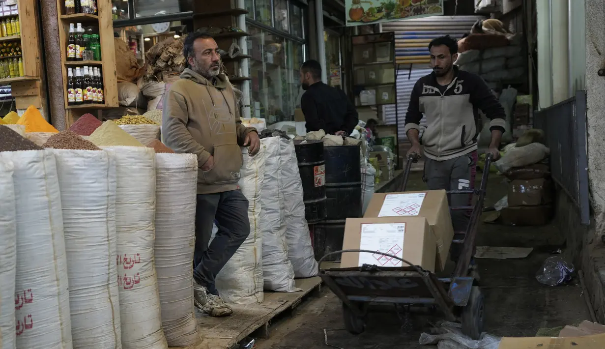 Seorang penjaga toko menunggu pelanggan di pasar utama Shurja di pusat Baghdad, Irak, pada 22 Maret 2022. Melonjaknya harga energi dan makanan yang dipicu oleh invasi Rusia ke Ukraina mendorong beberapa negara Timur Tengah ke tepi jurang.  (AP Photo/Hadi Mizban)