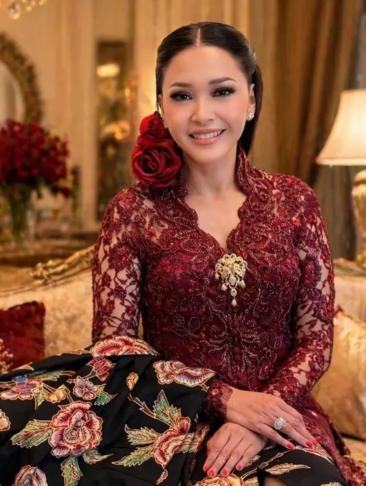 Tak kalah mencuri perhatian, Maia Estianty memilih tampil glamor dalam kebaya brokat merah maroon rancangan yang penuh detail payet. Kebaya tersebut dipadukan dengan kain batik hitam bermotif floral besar, menciptakan perpaduan klasik yang mewah.   [@maiaestiantyreal].