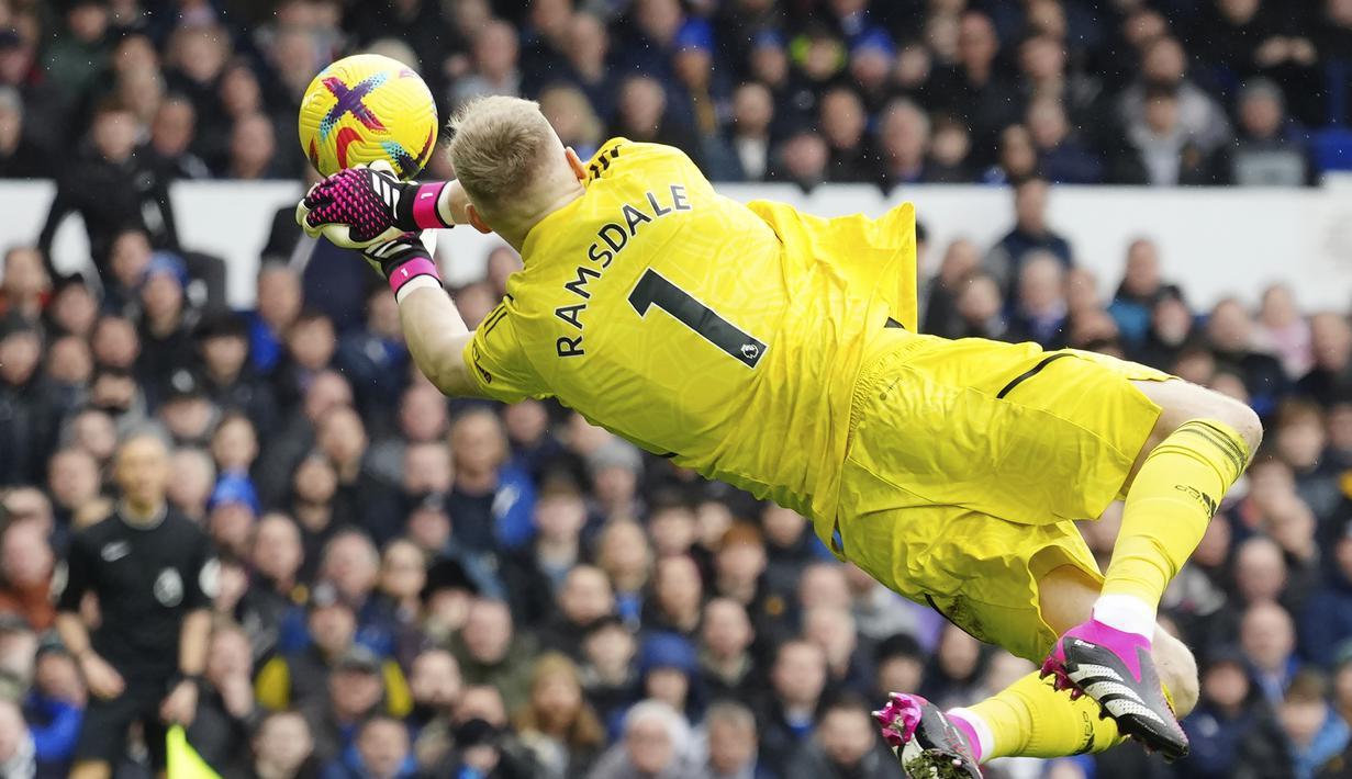 Kiper Arsenal, Aaron Ramsdale terbang untuk menepis bola dari ancaman pemain Everton dalam laga pekan ke-22 Liga Inggris 2022/2023 di Goodison Park, Liverpool, Sabtu (4/2/2023) malam WIB. (AP Photo/Jon Super)