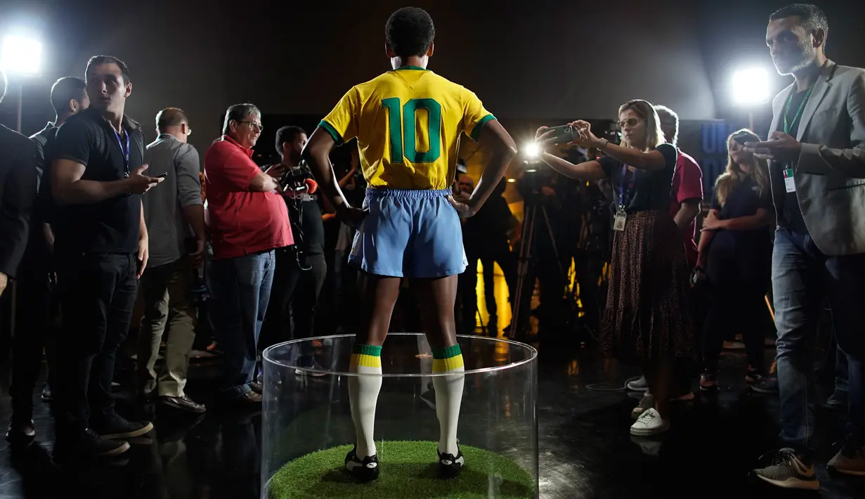 Wartawan mengambil gambar patung pemain sepak bola legendaris Brasil, Pele, di Museum Tim Sepak Bola Brasil di Rio de Janeiro, Kamis (20/2/2020). Konfederasi Sepak Bola Brasil meluncurkan patung Pele sebagai bagian dari peringatan 50 tahun sejak kemenangan Piala Dunia 1970. (AP/Leo Correa)