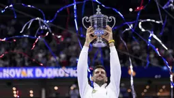 Petenis asal Serbia, Novak Djokovic, mengangkat trofi gelar juara US Open 2023 setelah mengalahkan petenis asal Rusia Daniil Medvedev dalam partai final yang berlangsung di Arthur Ashe, New York, Senin (11/9/2023) pagi WIB. Trofi ini merupakan gelar US Open keempat kalinya, dari 10 kali final yang telah dijalani oleh Djokovic. (AP Photo/Manu Fernandez)