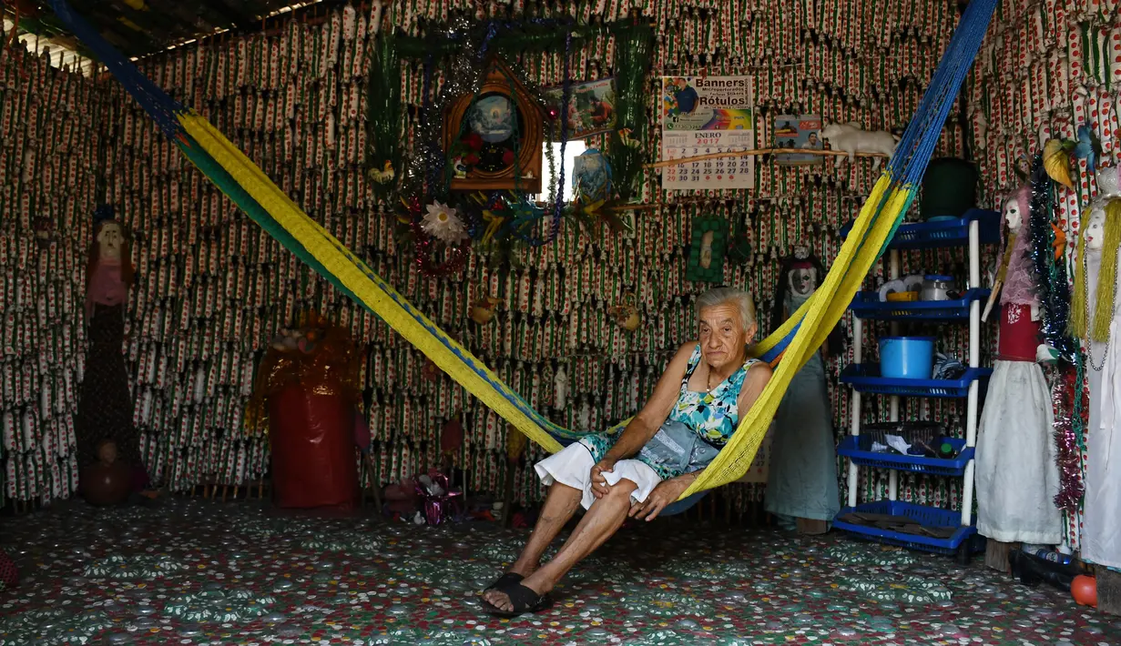 Maria Ponce (86) duduk di atas ayunan di Desa El Borbollon, El Transito, San Salvador, El Salvador 14 Maret 2017. Karena tak memiliki cukup uang nenek ini mendirikan rumah dengan menggunakan botol plastik. (AFP Photo/Marvin Recinos)