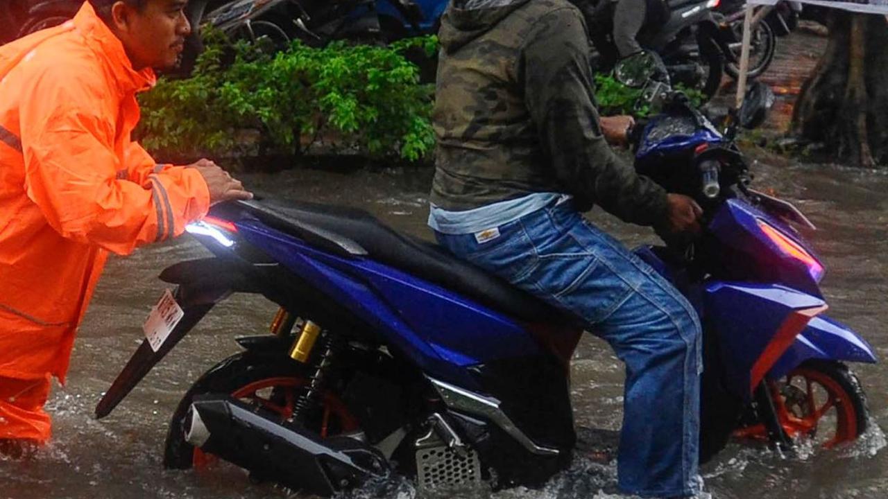 Beberapa kendaraan tampak mogok setelah nekat menerjang banjir.
