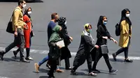 Warga Iran yang mengenakan masker menyeberang jalan di ibu kota Teheran, Sabtu (3/7/2021). Presiden Hassan Rouhani mengaku khawatir Iran akan dilanda gelombang kelima pandemi Covid-19 karena kemunculan virus corona varian Delta. (ATTA KENARE/AFP)