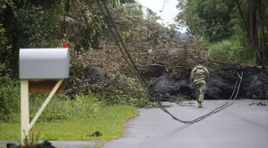 Garda Nasional Angkatan Darat AS memeriksa lahar dingin setelah letusan yang terjadi pada gunung berapi Kilauea di Hawaii (8/5). Gunung api tersebut telah memuntahkan lava dan gas sulfur dioksida dalam jumlah besar. (Mario Tama / Getty Images / AFP)